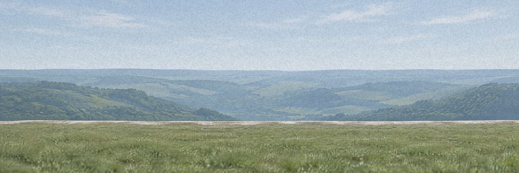The crown of Briar Hill: a smooth chalk rim above a wide green valley under a pale sky.
