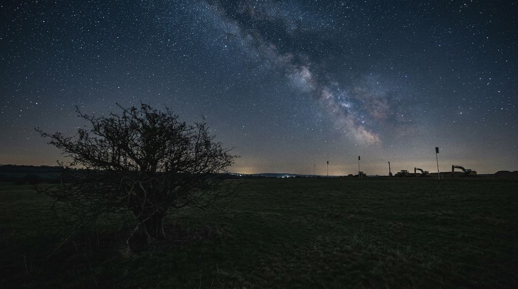 The Bramble Warren meadow at night: the hawthorn and the waiting machines under the stars.